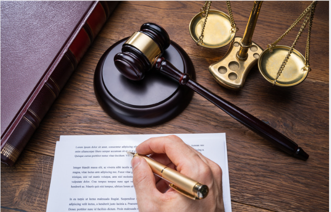 hand writing on legal papers and law equipment on table