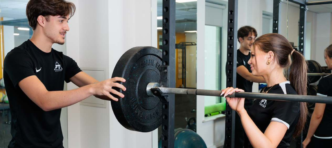 dartford_landscape_sports_pt_students_putting_weights_on_bar_2026