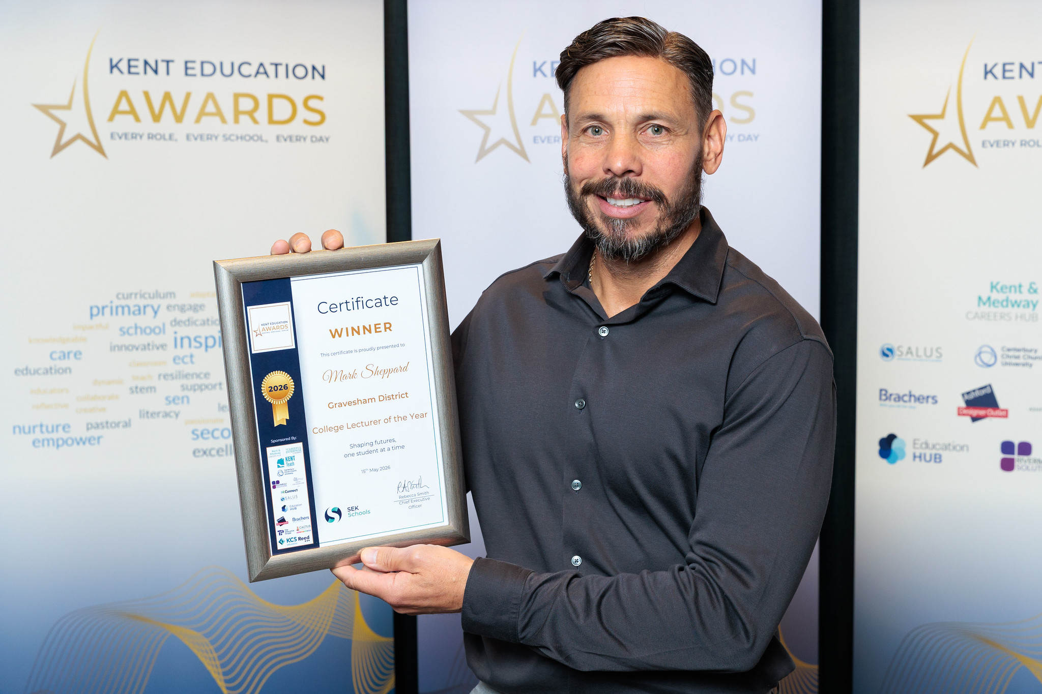 Mark Sheppard holds up his Kent Education Awards certificate